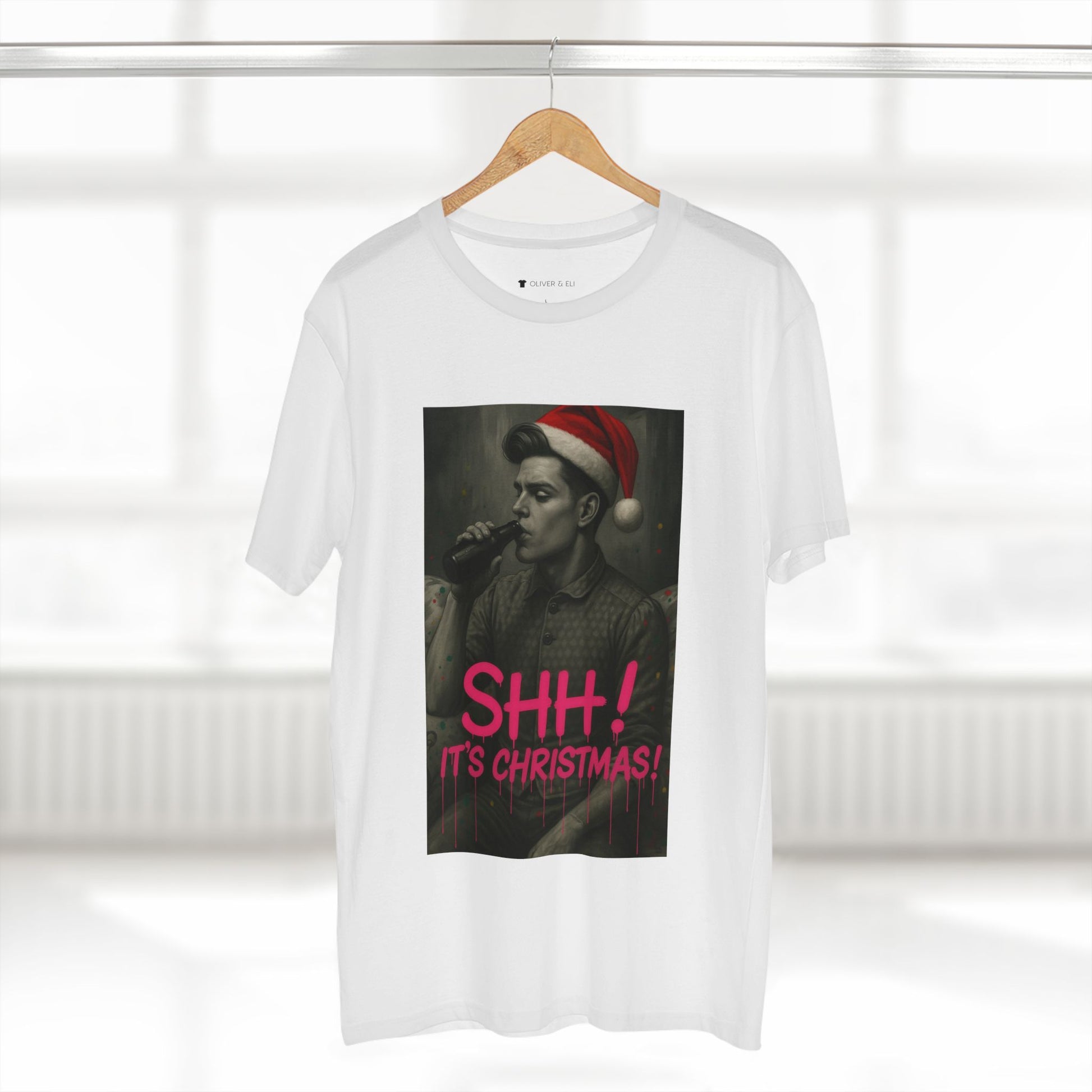 Model wearing tee from Oliver & Eli’s Sleigh Season collection — premium cotton Christmas t-shirt with graffiti print and festive design.