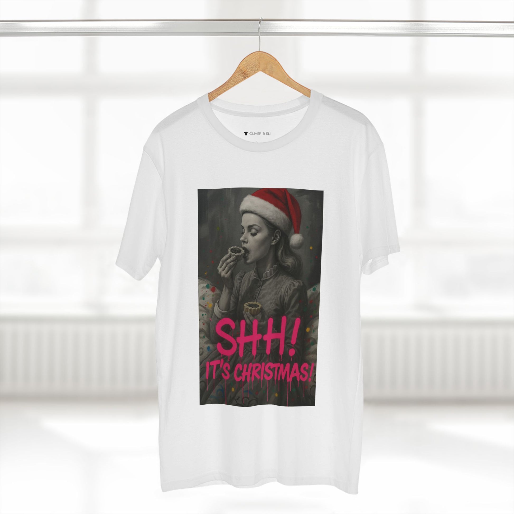 Model wearing tee from Oliver & Eli’s Sleigh Season collection — premium cotton Christmas t-shirt with graffiti print and festive design.